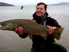 Ian Overbey has a reason to smile holding his Huge trout from Lake Thingvellir, Iceland